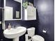 Charming powder room with pedestal sink, mirror, and stylish decor at 5306 Lavender Dr, Plainfield, IN 46168
