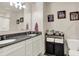 Bright bathroom features a granite countertop, white cabinets, and a double sink vanity at 5306 Lavender Dr, Plainfield, IN 46168
