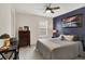 Comfortable bedroom featuring neutral-toned walls, a ceiling fan, and a cozy bed at 5306 Lavender Dr, Plainfield, IN 46168