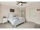 Cozy bedroom featuring a comfortable bed, ceiling fan, and a white door at 5306 Lavender Dr, Plainfield, IN 46168