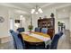 Traditional dining room with wood table, seating for six, wood floors, and classic furnishings at 5306 Lavender Dr, Plainfield, IN 46168