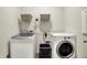 Practical laundry room featuring modern washer and dryer units and extra storage at 5306 Lavender Dr, Plainfield, IN 46168