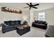 Bright living room features two sofas, a dark coffee table, and a ceiling fan at 5306 Lavender Dr, Plainfield, IN 46168