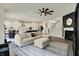 Open-concept living room with a large sectional sofa and views of the kitchen and dining area at 5306 Lavender Dr, Plainfield, IN 46168