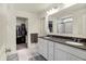Bright primary bathroom with double vanity, granite counters, and a tiled shower at 5306 Lavender Dr, Plainfield, IN 46168