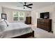 Inviting main bedroom with a ceiling fan, large window and dresser at 5306 Lavender Dr, Plainfield, IN 46168
