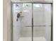 Tiled shower features glass doors, built-in shelves, and a window for natural light at 5306 Lavender Dr, Plainfield, IN 46168