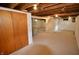 Unfinished basement with exposed ceiling, sealed floors, and closet space at 5430 E 17Th St, Indianapolis, IN 46218