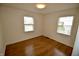 Cozy bedroom with hardwood floors and natural light from two windows at 5430 E 17Th St, Indianapolis, IN 46218
