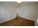 Empty bedroom featuring hardwood floors, neutral walls, and closet space at 5430 E 17Th St, Indianapolis, IN 46218