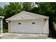 Detached garage with a freshly painted door for secure parking and additional storage at 5430 E 17Th St, Indianapolis, IN 46218