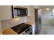 Modern kitchen featuring white cabinets, stainless steel appliances, and butcher block countertops at 5430 E 17Th St, Indianapolis, IN 46218