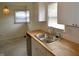 Close-up of a kitchen sink with butcher block countertops, stainless steel faucet, and white cabinets at 5430 E 17Th St, Indianapolis, IN 46218