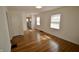 Inviting living room featuring hardwood floors, fresh paint, and a view of the kitchen at 5430 E 17Th St, Indianapolis, IN 46218