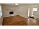 Spacious living room featuring hardwood floors, a fireplace, and ample natural light at 5430 E 17Th St, Indianapolis, IN 46218
