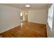 Sunlit living room with newly refinished hardwood floors and fresh paint at 5430 E 17Th St, Indianapolis, IN 46218