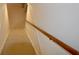 Carpeted stairs with wooden handrail leading to basement at 5430 E 17Th St, Indianapolis, IN 46218