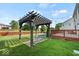 Inviting backyard featuring a pergola swing, wood deck, and lush green lawn at 5960 Dado Dr, Noblesville, IN 46062