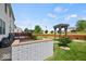 Private backyard with a patio area, pergola, string lights, and manicured landscaping at 5960 Dado Dr, Noblesville, IN 46062