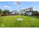 Expansive backyard with a fire pit, pergola, and well-manicured lawn at 5960 Dado Dr, Noblesville, IN 46062