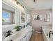 Bright bathroom featuring dual sinks, soaking tub, and decorative accents at 5960 Dado Dr, Noblesville, IN 46062