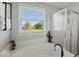 Relaxing bathroom with soaking tub, walk-in shower, and backyard views at 5960 Dado Dr, Noblesville, IN 46062