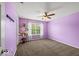 Bedroom with purple walls, ceiling fan, carpet flooring, and natural light from a window at 5960 Dado Dr, Noblesville, IN 46062