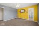 Spacious bedroom with gray and yellow walls, carpet flooring, ceiling fan, and a closet at 5960 Dado Dr, Noblesville, IN 46062