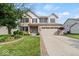 Charming two-story home with brick facade, two-car garage, manicured lawn, and beautiful landscaping at 5960 Dado Dr, Noblesville, IN 46062