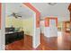 Hallway featuring hardwood floors, access to a well-lit office, and views of the living spaces at 5960 Dado Dr, Noblesville, IN 46062