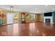 Spacious living room featuring hardwood floors, a fireplace, sliding doors to a patio, and ample natural light at 5960 Dado Dr, Noblesville, IN 46062