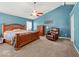 Main bedroom features a ceiling fan, large bed, and comfortable seating at 5960 Dado Dr, Noblesville, IN 46062