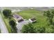 An aerial view showcasing the home, detached garage, driveway, and sprawling green yard at 5964 N Pr Wind Drift Ln, Shelbyville, IN 46176