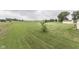 Large lot with manicured lawn and mature trees creates a serene outdoor space at 5964 N Pr Wind Drift Ln, Shelbyville, IN 46176