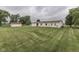 Expansive, green backyard featuring a well-maintained lawn and a detached garage at 5964 N Pr Wind Drift Ln, Shelbyville, IN 46176
