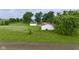 Expansive backyard with mature trees, a detached garage and ample space for outdoor activities at 5964 N Pr Wind Drift Ln, Shelbyville, IN 46176