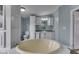 Bathroom with a large soaking tub, white cabinets, and blue walls at 5964 N Pr Wind Drift Ln, Shelbyville, IN 46176