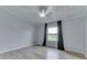 Bedroom with a ceiling fan, wood-look floors, and a view of the countryside at 5964 N Pr Wind Drift Ln, Shelbyville, IN 46176