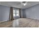 The primary bedroom is spacious with neutral walls, bright windows, and stylish plank flooring at 5964 N Pr Wind Drift Ln, Shelbyville, IN 46176
