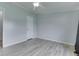 Bedroom with a ceiling fan and wood-look floors at 5964 N Pr Wind Drift Ln, Shelbyville, IN 46176