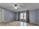 The primary bedroom is spacious with neutral walls, bright windows, and stylish plank flooring at 5964 N Pr Wind Drift Ln, Shelbyville, IN 46176