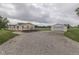 Spacious driveway and the exterior of the home with a detached garage in the background at 5964 N Pr Wind Drift Ln, Shelbyville, IN 46176
