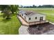 Side view of the home, showing the deck, landscaping, and yard space at 5964 N Pr Wind Drift Ln, Shelbyville, IN 46176