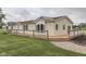 Ranch home boasting a wooden deck with lovely stone walkway and a well-maintained lawn at 5964 N Pr Wind Drift Ln, Shelbyville, IN 46176