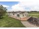 Charming, ranch-style home with a large wooden deck overlooking a spacious yard and agricultural field at 5964 N Pr Wind Drift Ln, Shelbyville, IN 46176