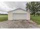 A well-maintained detached garage features neutral siding and a spacious driveway at 5964 N Pr Wind Drift Ln, Shelbyville, IN 46176