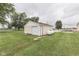 Detached garage with plenty of storage space and a propane tank, surrounded by green lawns at 5964 N Pr Wind Drift Ln, Shelbyville, IN 46176