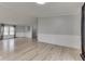 Open-concept living room features modern wood-look floors and neutral walls with traditional wainscoting at 5964 N Pr Wind Drift Ln, Shelbyville, IN 46176