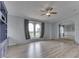 Open-concept living room features modern wood-look floors, neutral walls, and built-in shelves and cabinets at 5964 N Pr Wind Drift Ln, Shelbyville, IN 46176