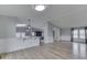 Spacious living room and eat-in kitchen features wood-look floors, neutral walls, and modern lighting at 5964 N Pr Wind Drift Ln, Shelbyville, IN 46176
